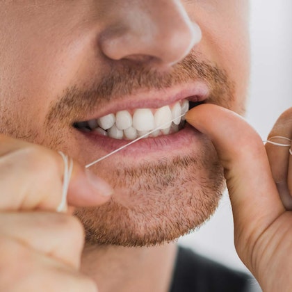 Man flossing teeth