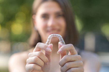 Woman holding an invisalign