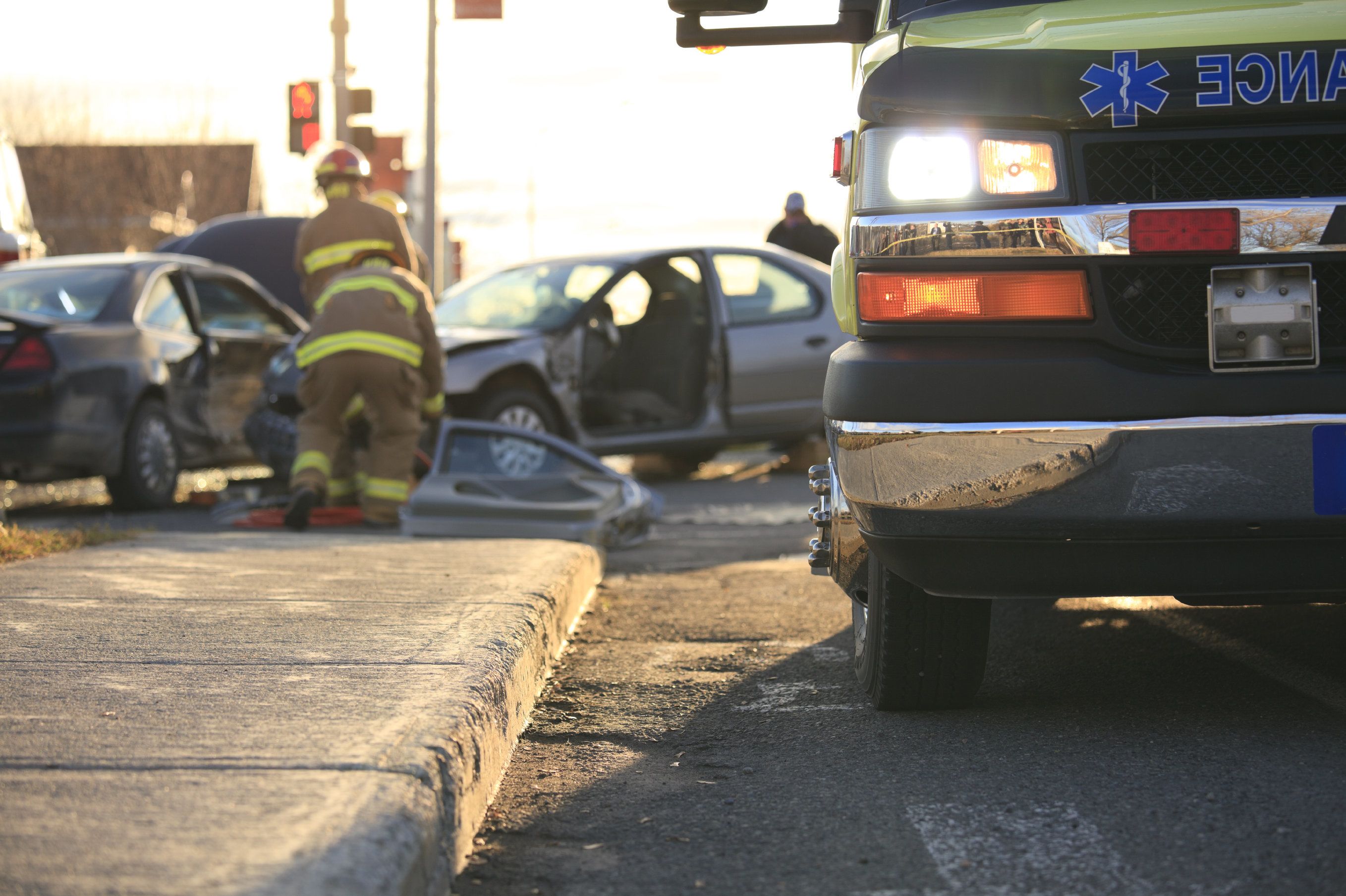 Ambulance and staff attending to bad car accident due to drunk driving