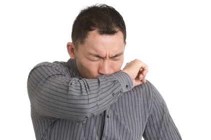 Man coughing into his arm