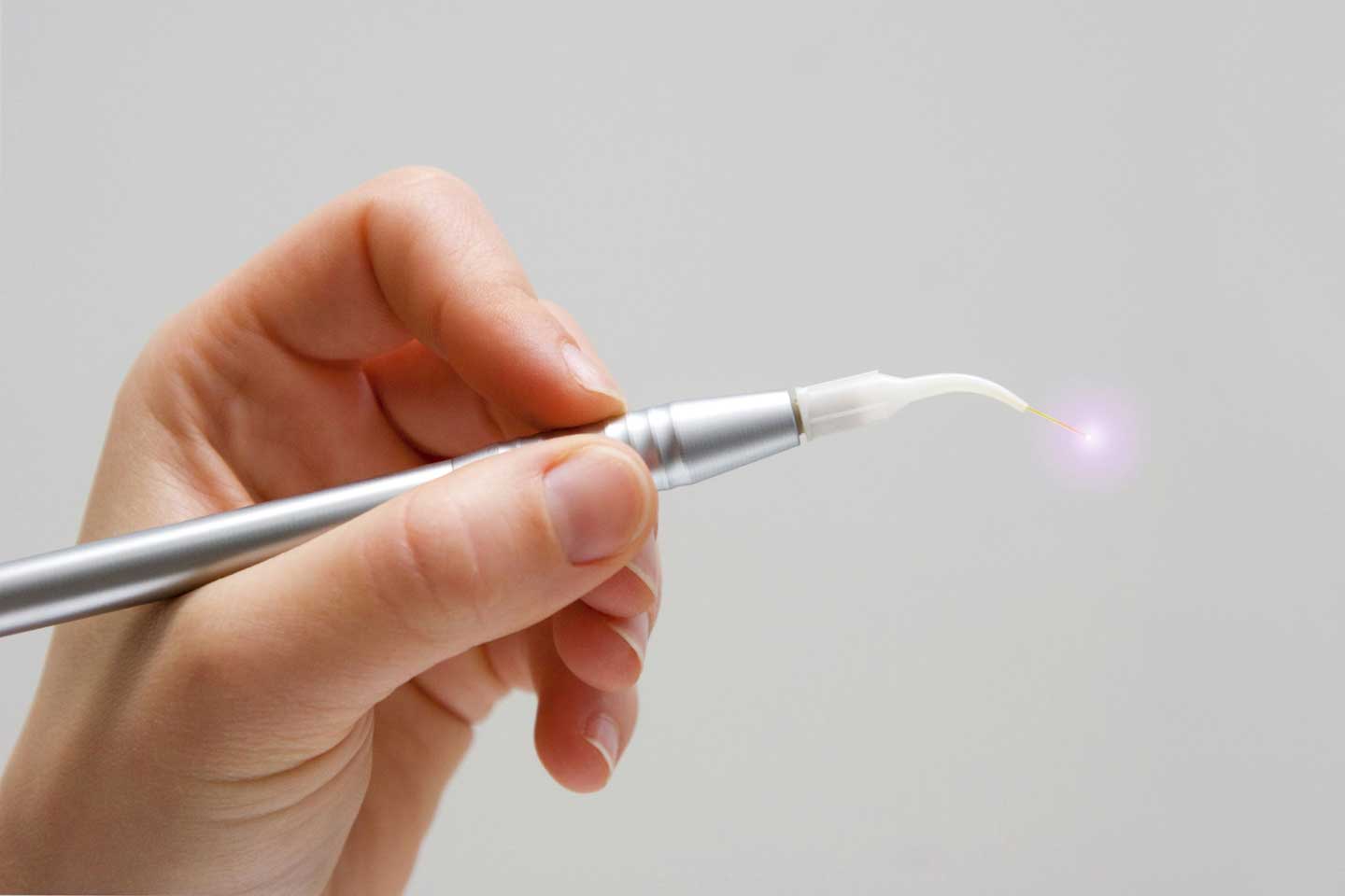 Hand holding dental laser