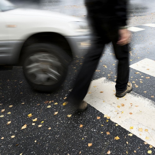 Blurred image of pedestrian crossing busy road