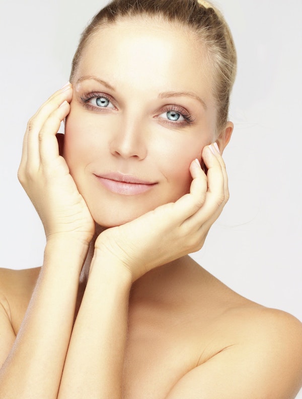 woman holding her face