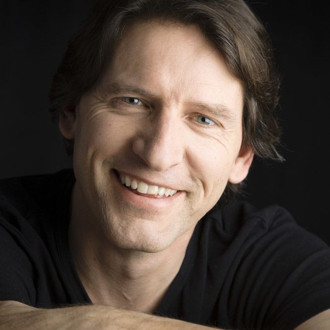 Smiling dark-haired man in a black t-shirt
