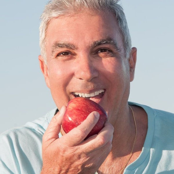 Older man biting apple