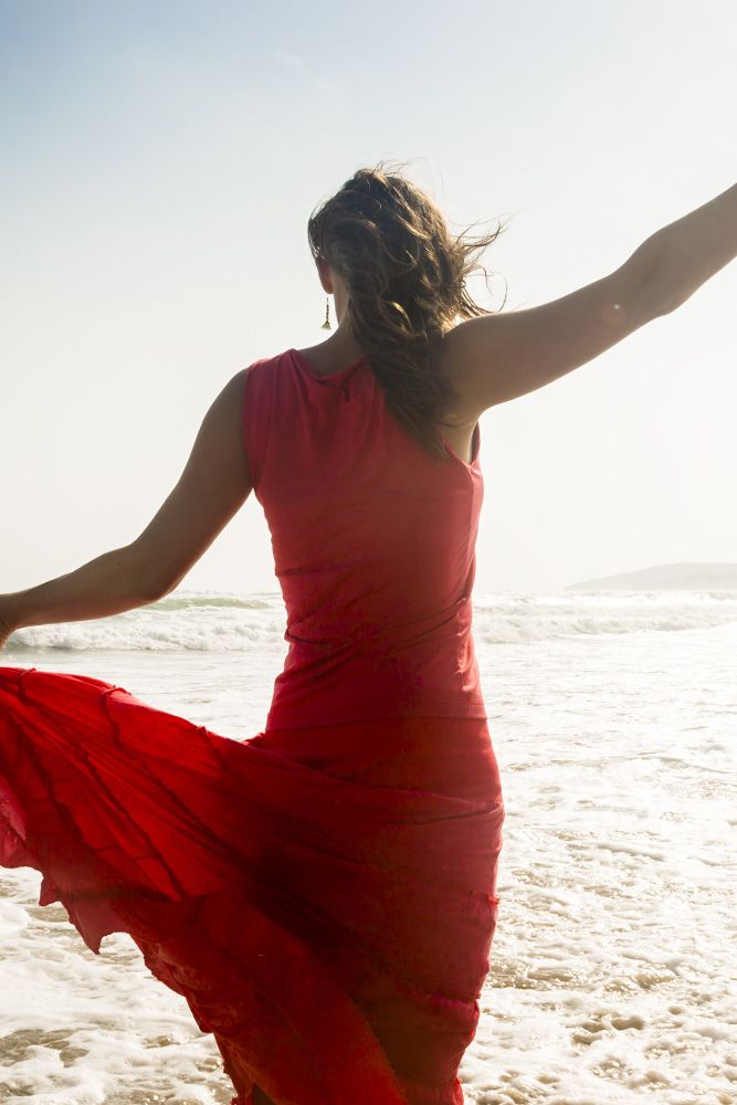 Woman at beach in red dress