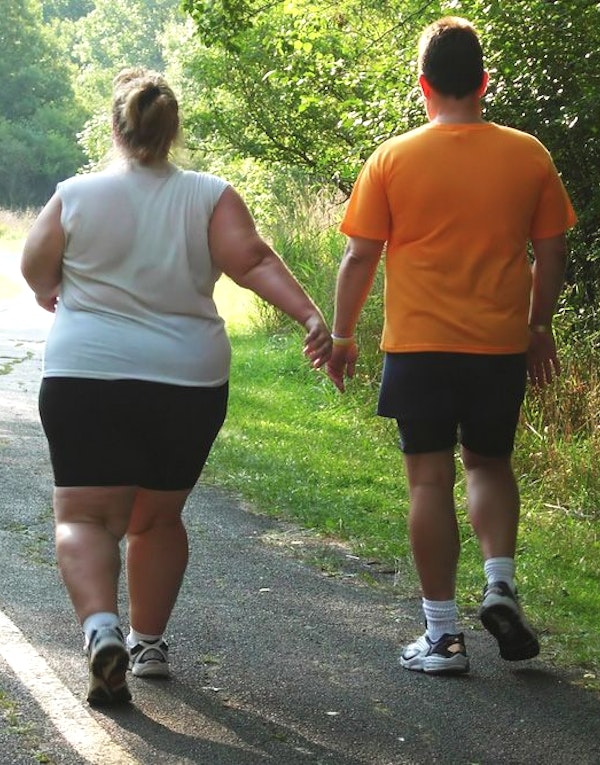 overweight couple walking