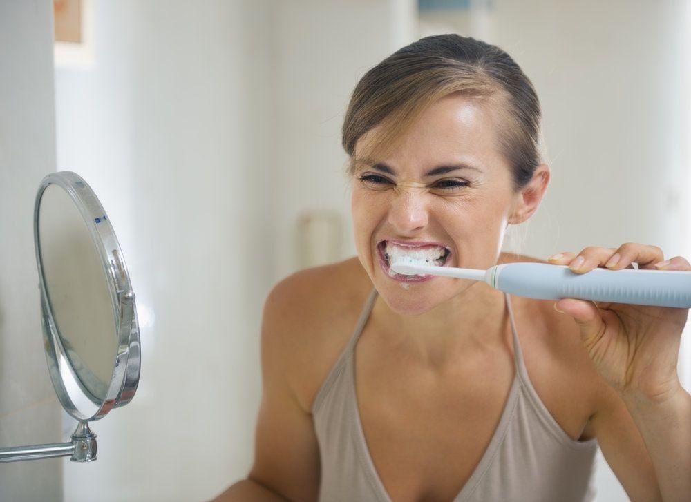 woman brushing teeth