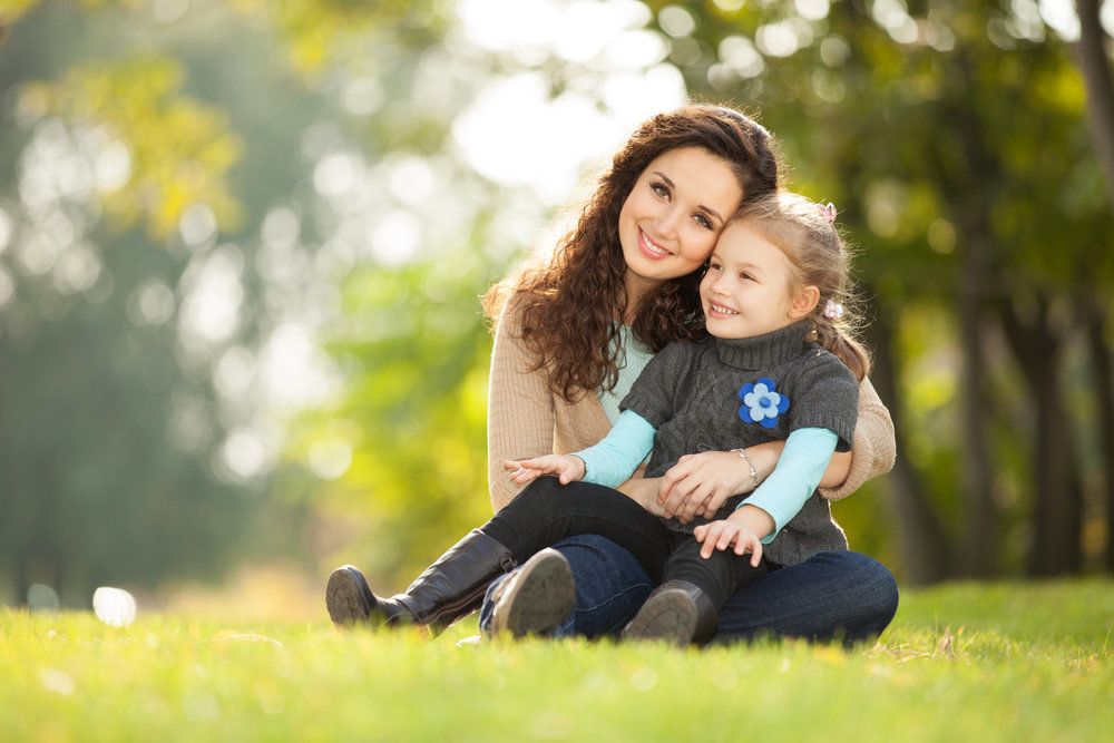 Mother and her young child outside in a park