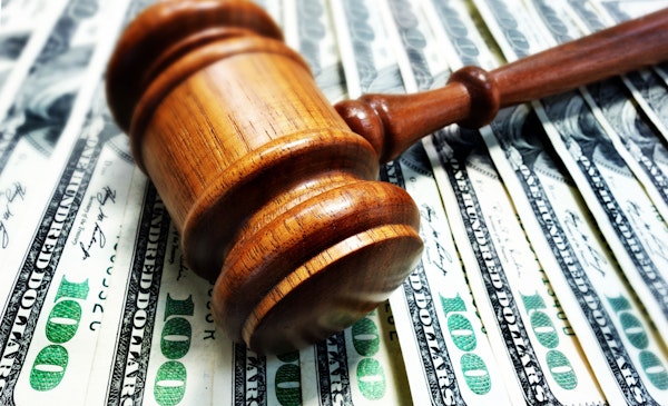 Gavel on top of cash