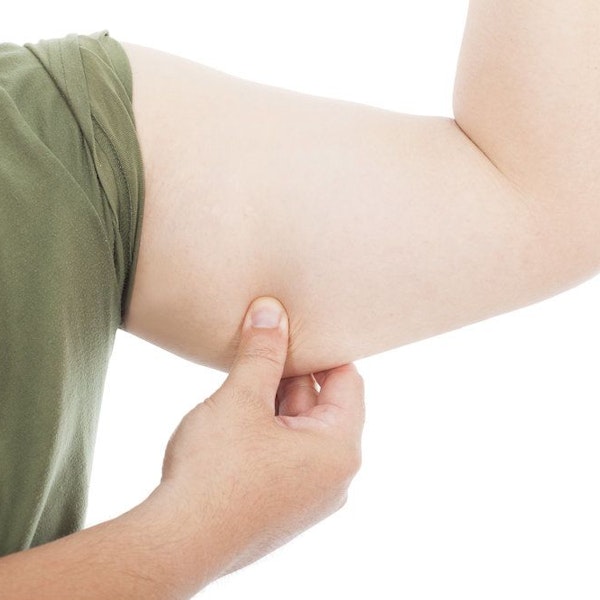 Man pinching skin on upper arm