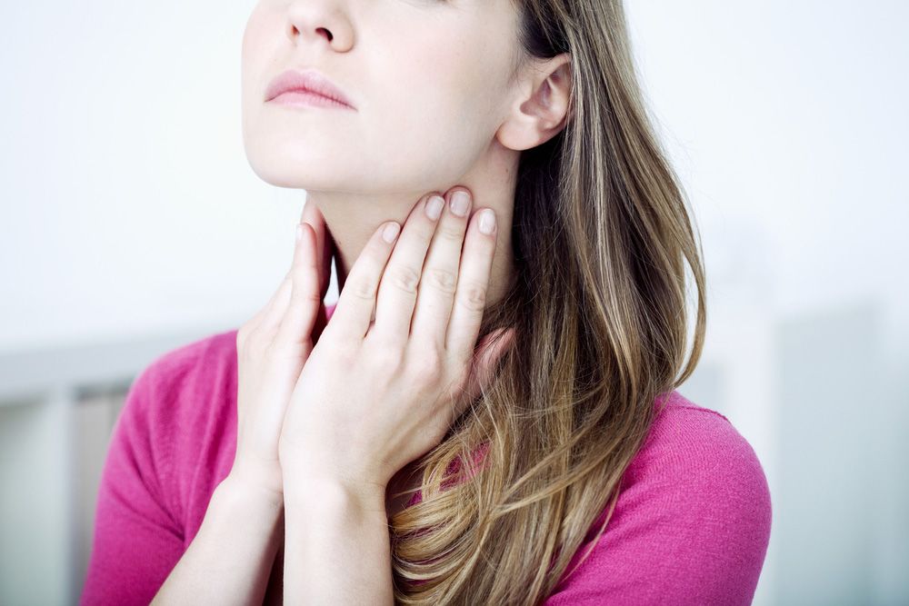 Woman touching neck