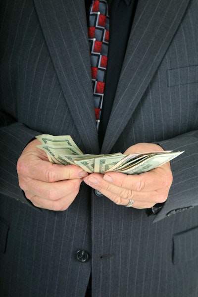 Business man holding dollar bills