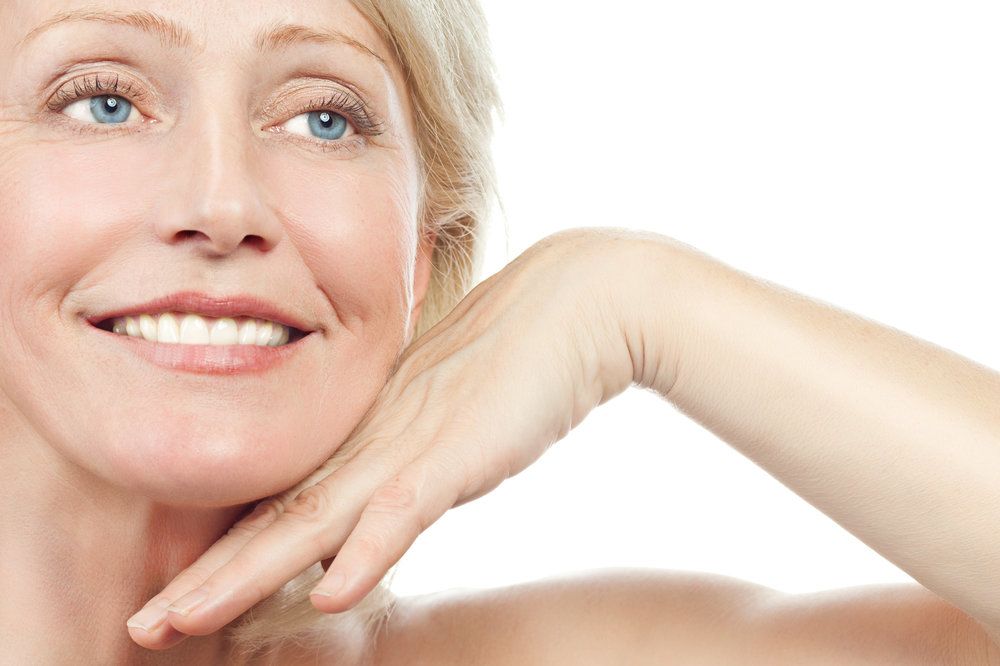 woman holding her hand to her chin 