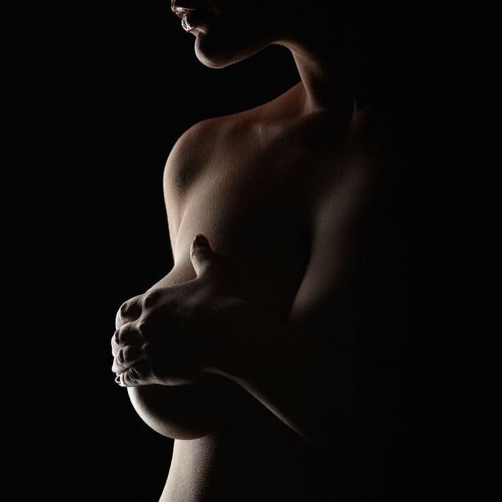 Woman with hand over breast