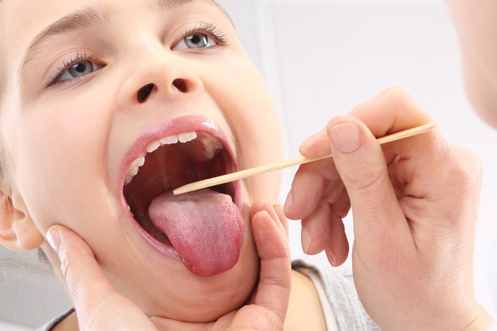 Child undergoing a throat exam