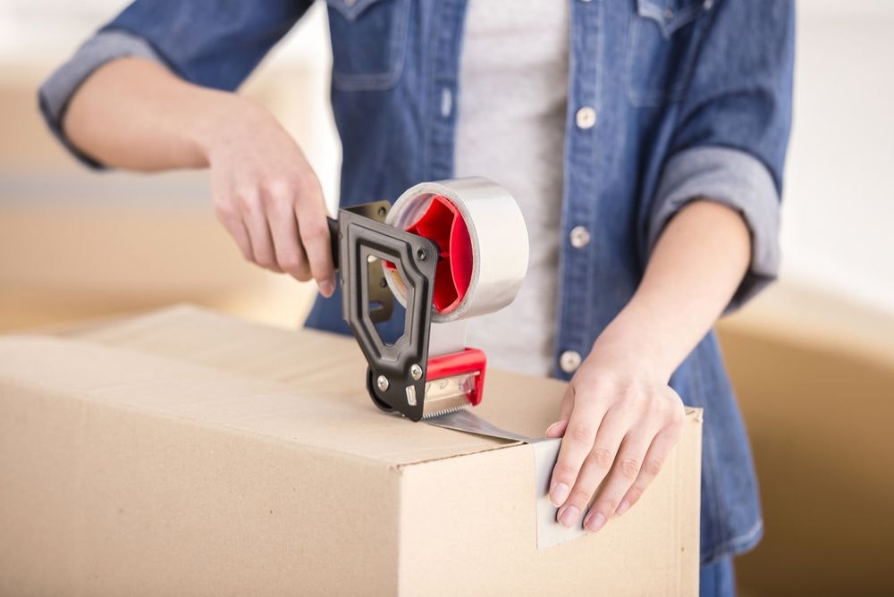 man packing a box