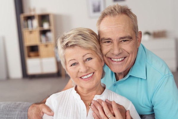 A senior couple smiling at the camera