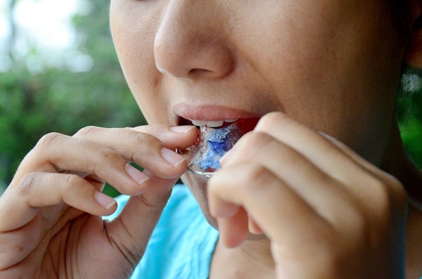 Patient putting on orthodontic appliance