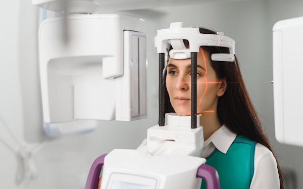 Woman getting 3D imaging with cone beam scanner