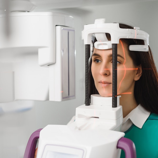 Woman getting 3D imaging with cone beam scanner