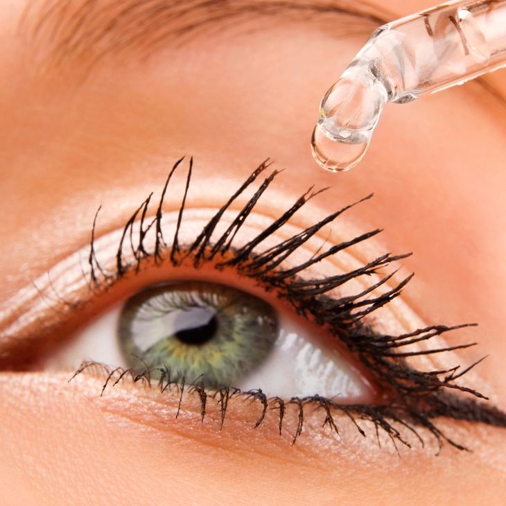 Eye drop being administered to a woman