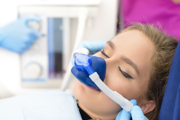 Woman with nitrous mask relaxing
