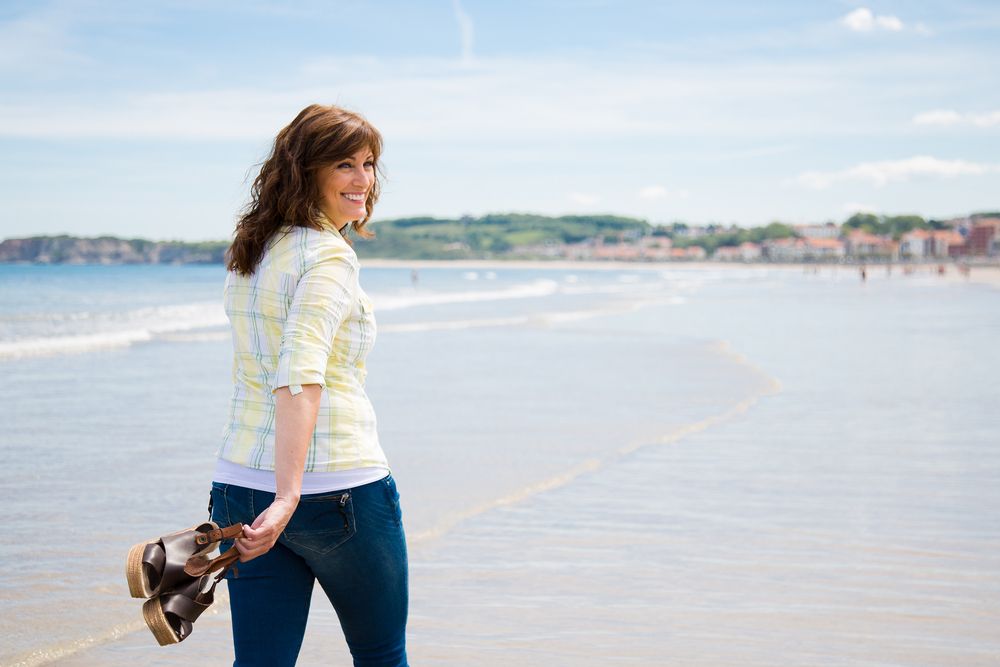 woman enjoying a walk along the beach
