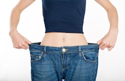 woman in large pants holding out the waistline