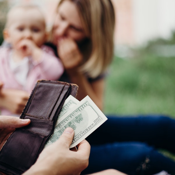 Wallet and cash in front of child support recipient