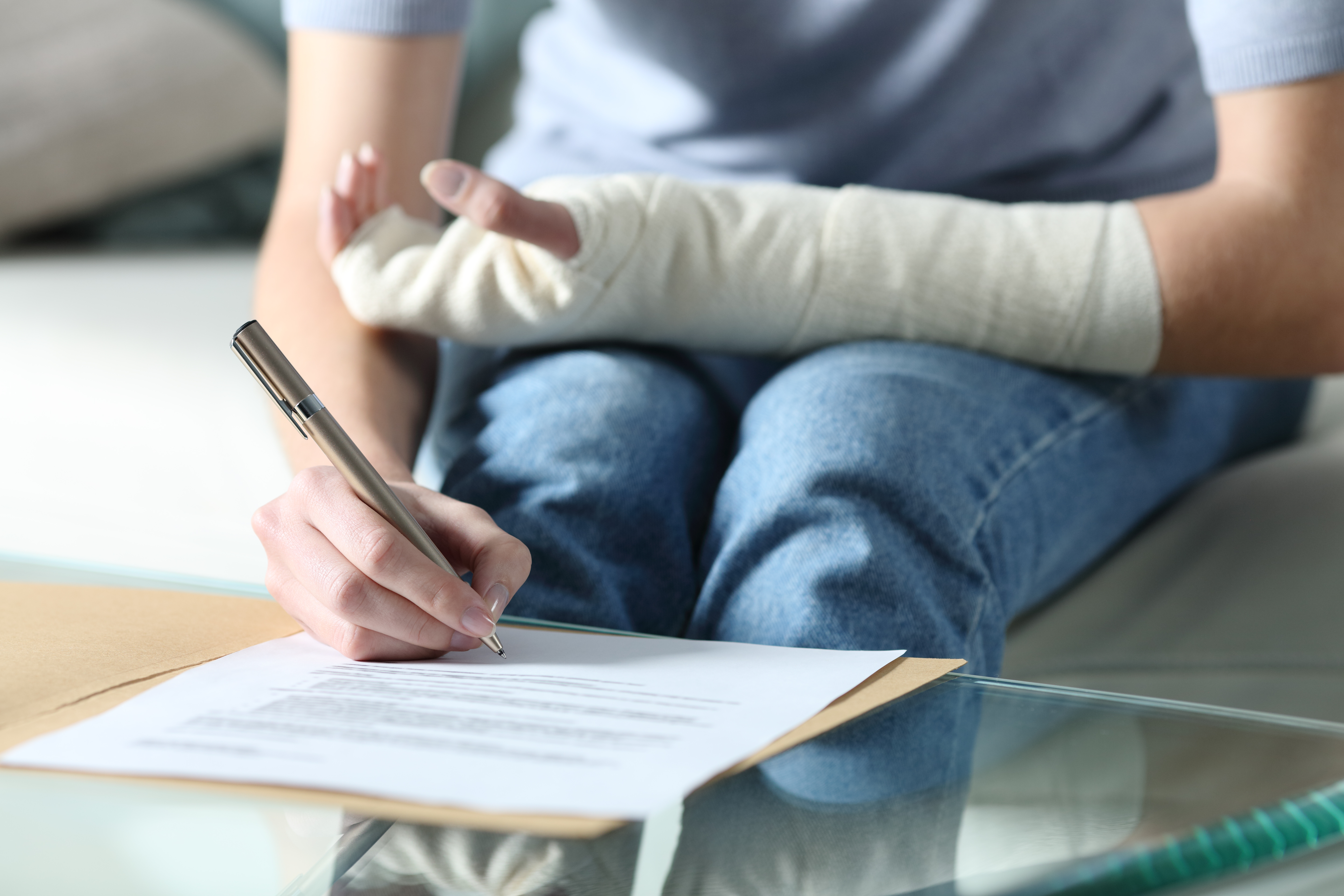 Person with bitten and injured arm signing paperwork