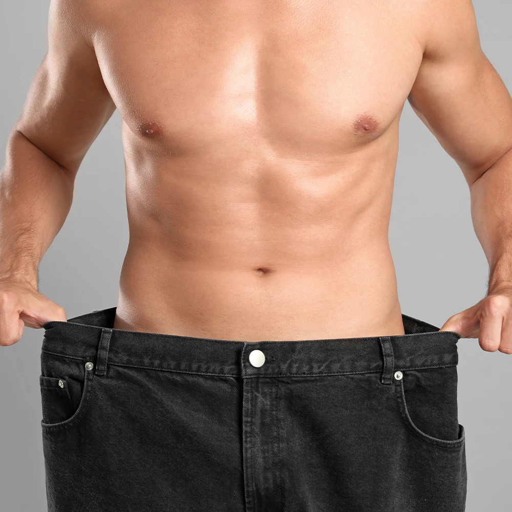 Man holding large pants around his waist