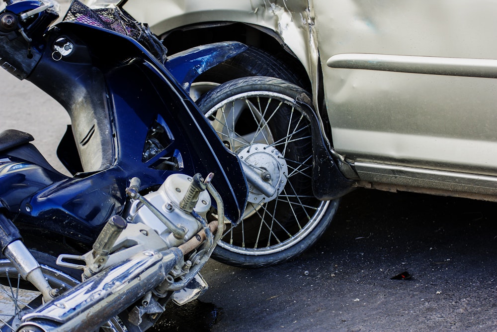 Closeup of totaled motorcycle after collision with car