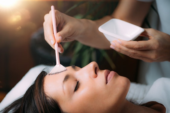 Woman receiving chemical peel mask