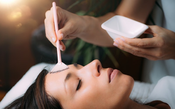 Woman receiving chemical peel mask