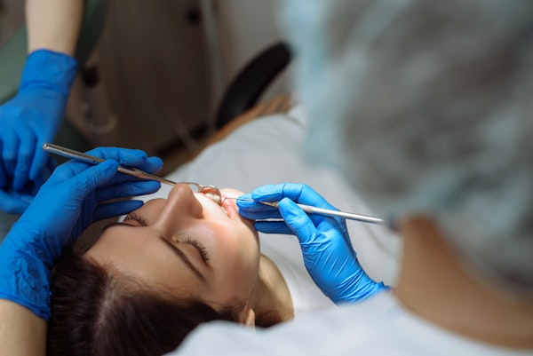 Woman getting dental work done