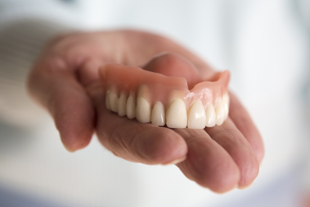 Denture in hand
