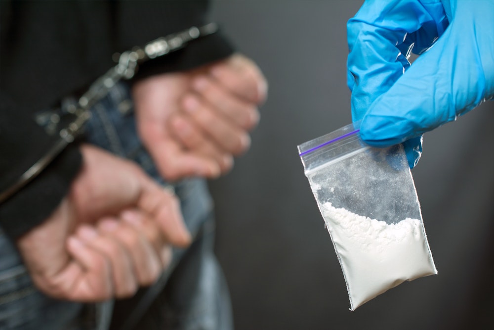 Police holding drugs while person is arrested