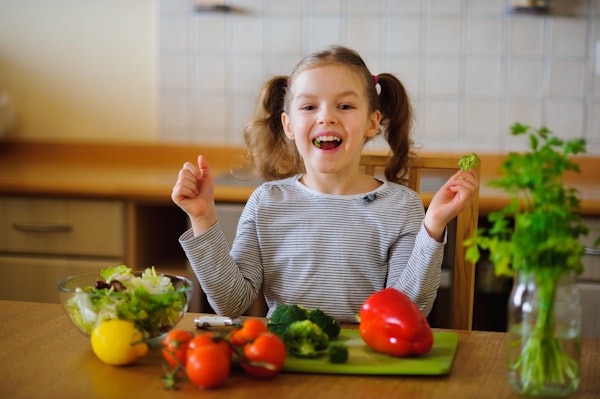 Girl eating veggies
