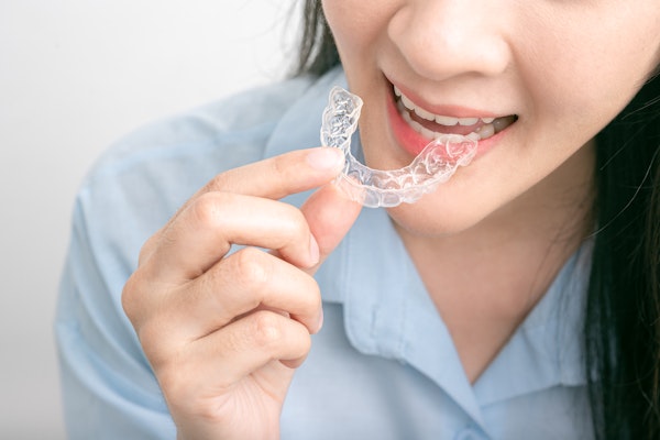 Woman putting in clear aligners