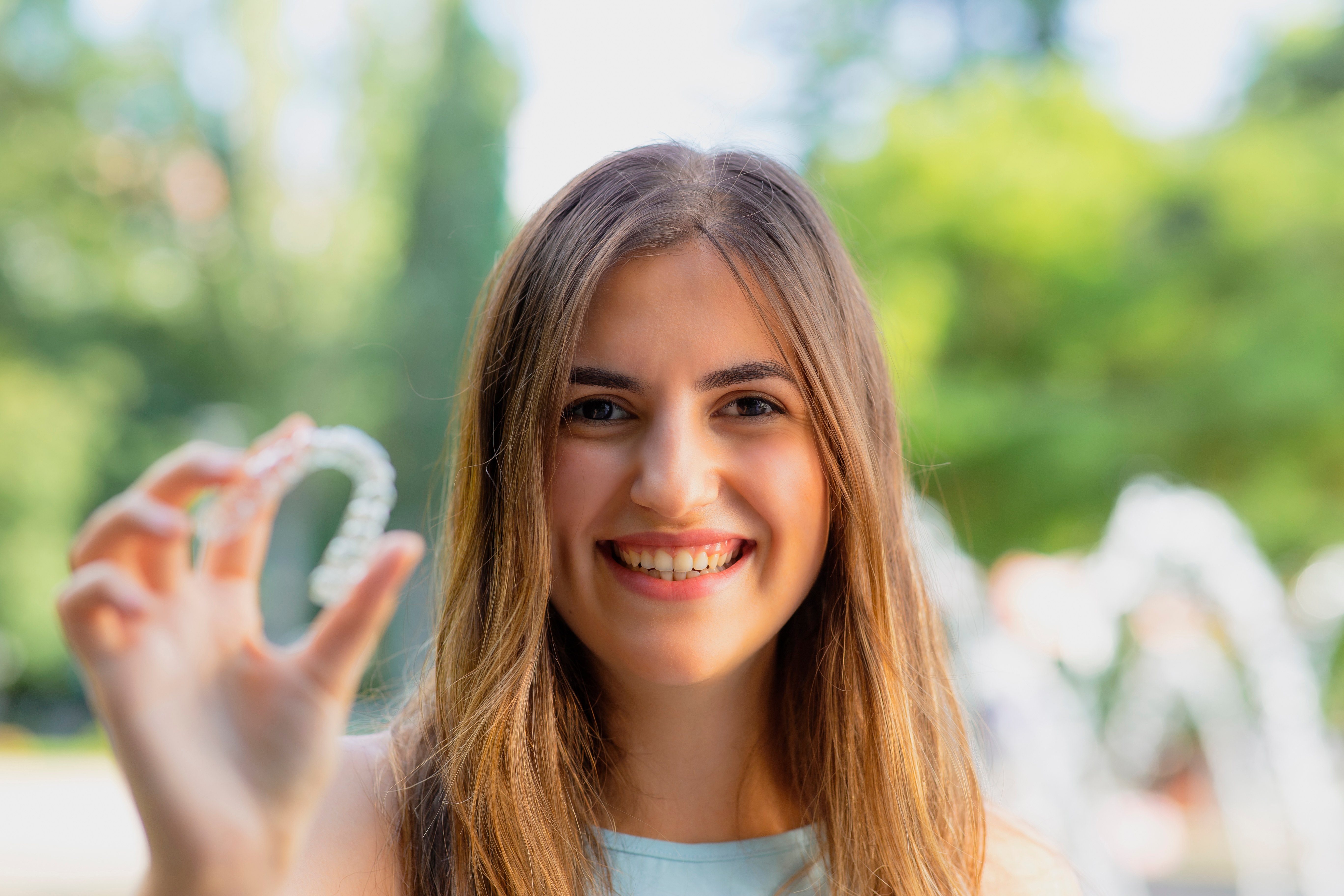 Girl holding invisalign