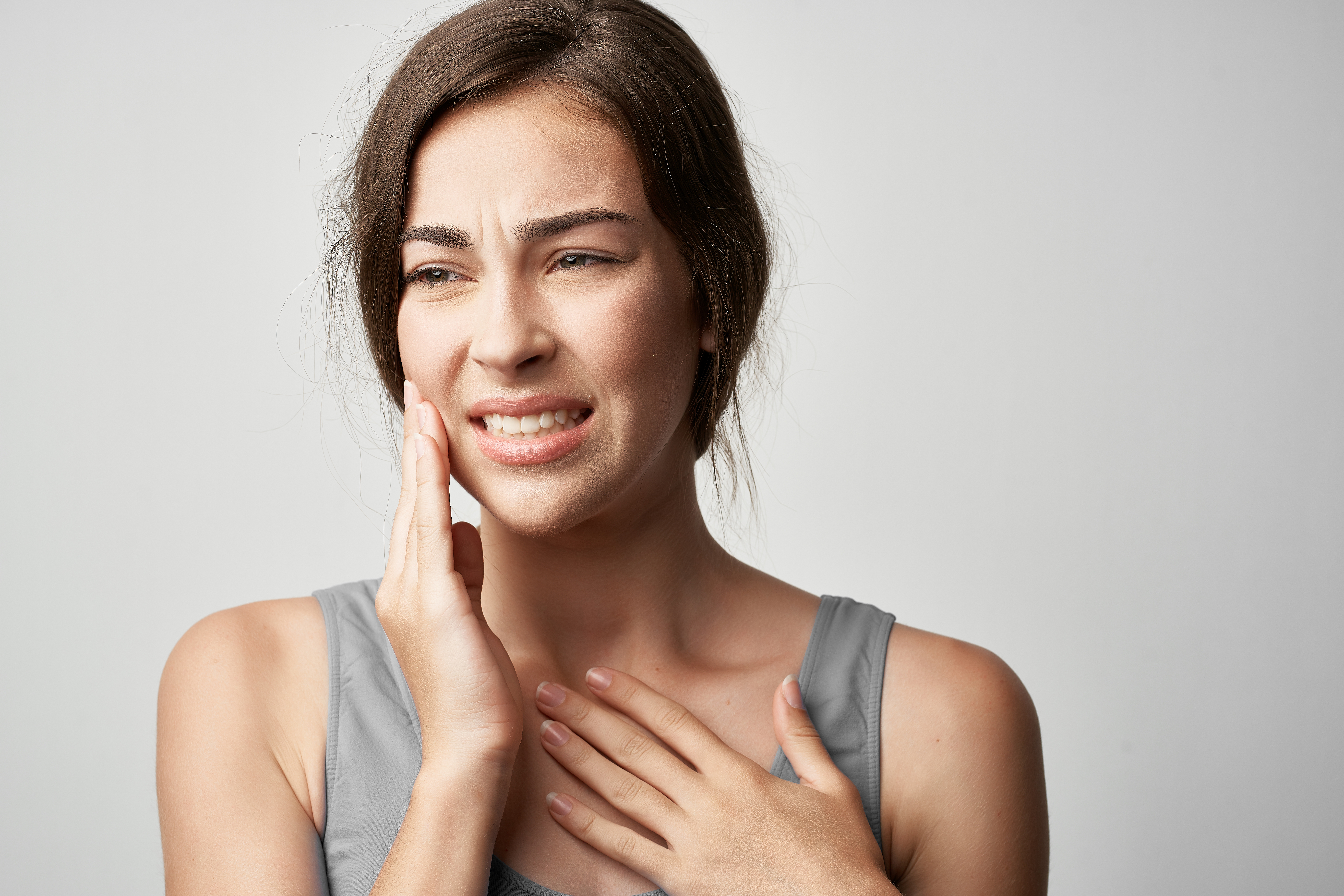Woman holding her jaw
