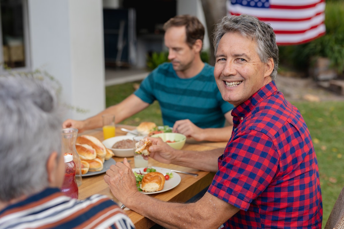Smiling man at BBQ with friends