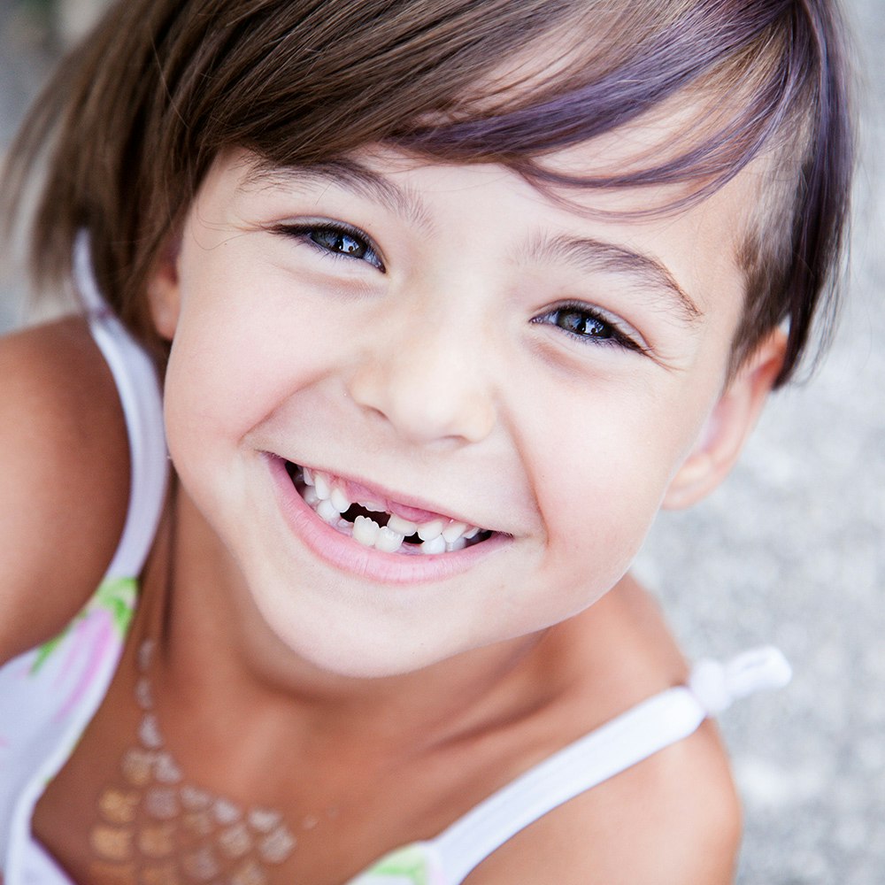 Smiling girl with missing teeth