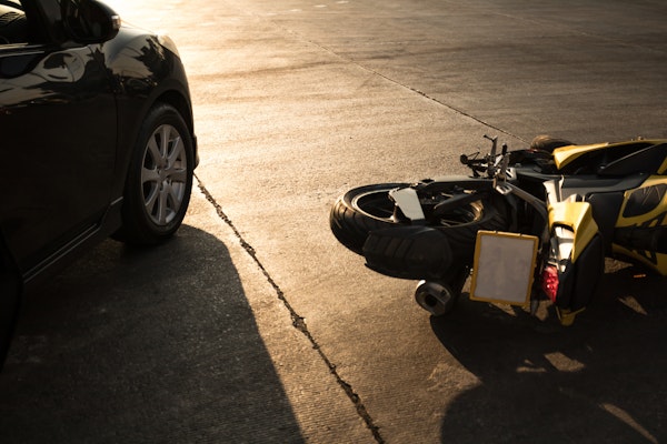 Close up of a fallen motorcycle and car