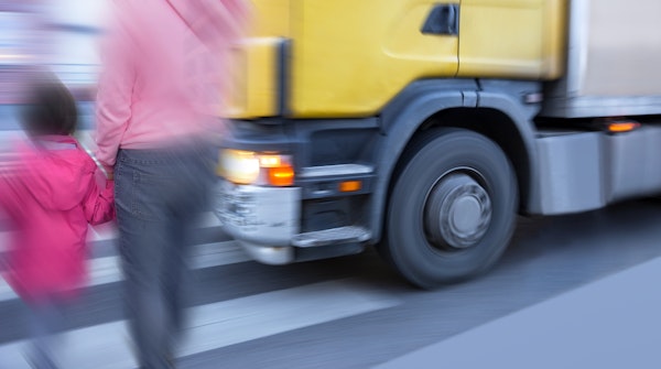Pedestrians crossing while truck is right in front of them