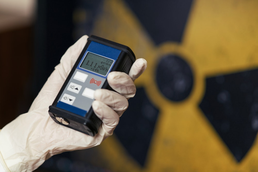Person holding Geiger Counter