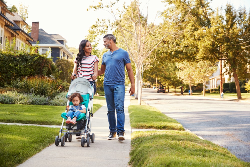 Couple with child walking on sidewalk