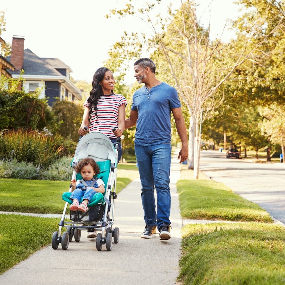Couple with child walking on sidewalk