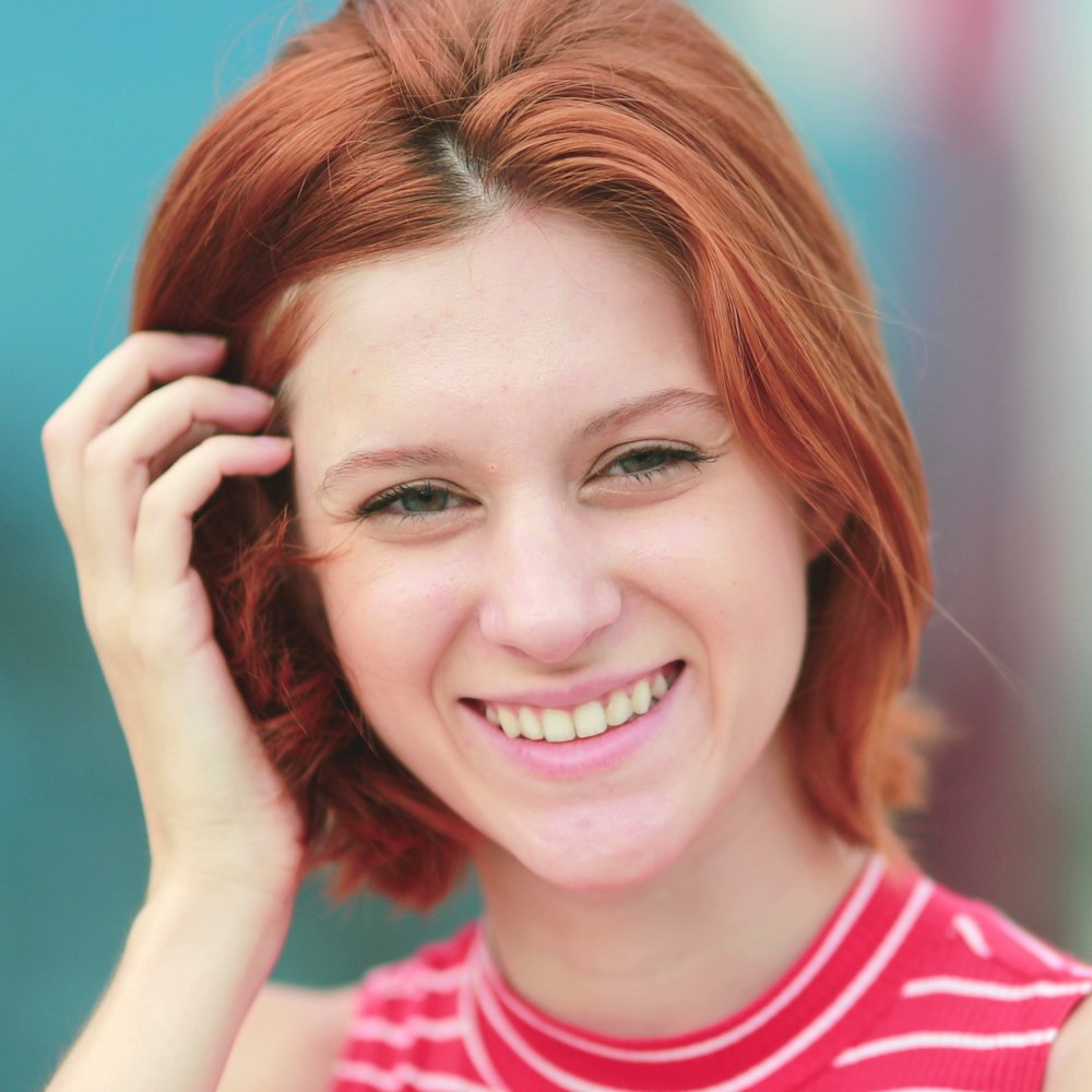 Smiling lady tucking back hair